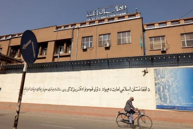 a man rides a bike in front of the bank of afghanistan in kabul afghanistan october 8 2021 reuters jorge silva file photo a man rides a bike in front of the bank of afghanistan in kabul afghanistan october 8 2021 reuters jorge silva file photo