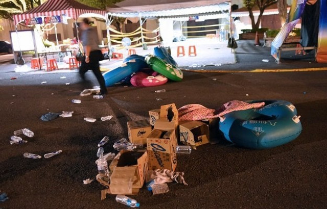 a police officer walks past debris at the formosa fun coast amusement park after an explosion in the pali district of new taipei city early june 28 2015 photo afp a police officer walks past debris at the formosa fun coast amusement park after an explosion in the pali district of new taipei city early june 28 2015 photo afp