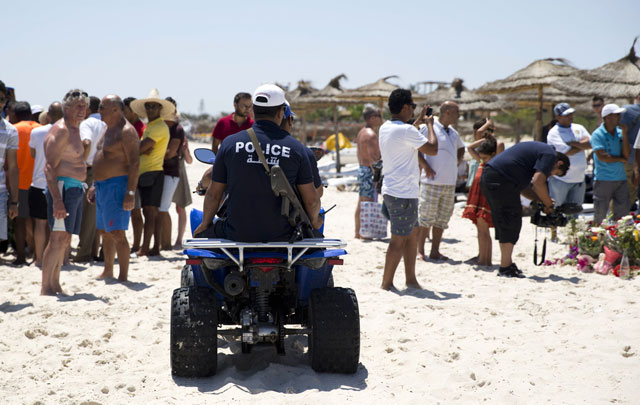 tunisian policemen patrol the beach in front of the riu imperial marhaba hotel in port el kantaoui on the outskirts of sousse south of the capital tunis on june 28 2015 following a shooting attack two days earlier photo afp