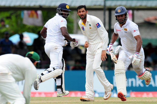 sri lankan cricketer dimuth karunaratne r and captain angelo mathews 2l run between the wickets as pakistan cricketer junaid khan 2r looks on during the final day of the second test cricket match between sri lanka and pakistan at the p sara oval cricket stadium in colombo on june 29 2015 photo afp