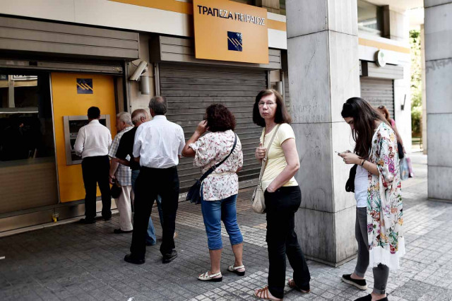 people queue to withdraw cash from an atm machine in central athens on june 30 2015 photo afp people queue to withdraw cash from an atm machine in central athens on june 30 2015 photo afp