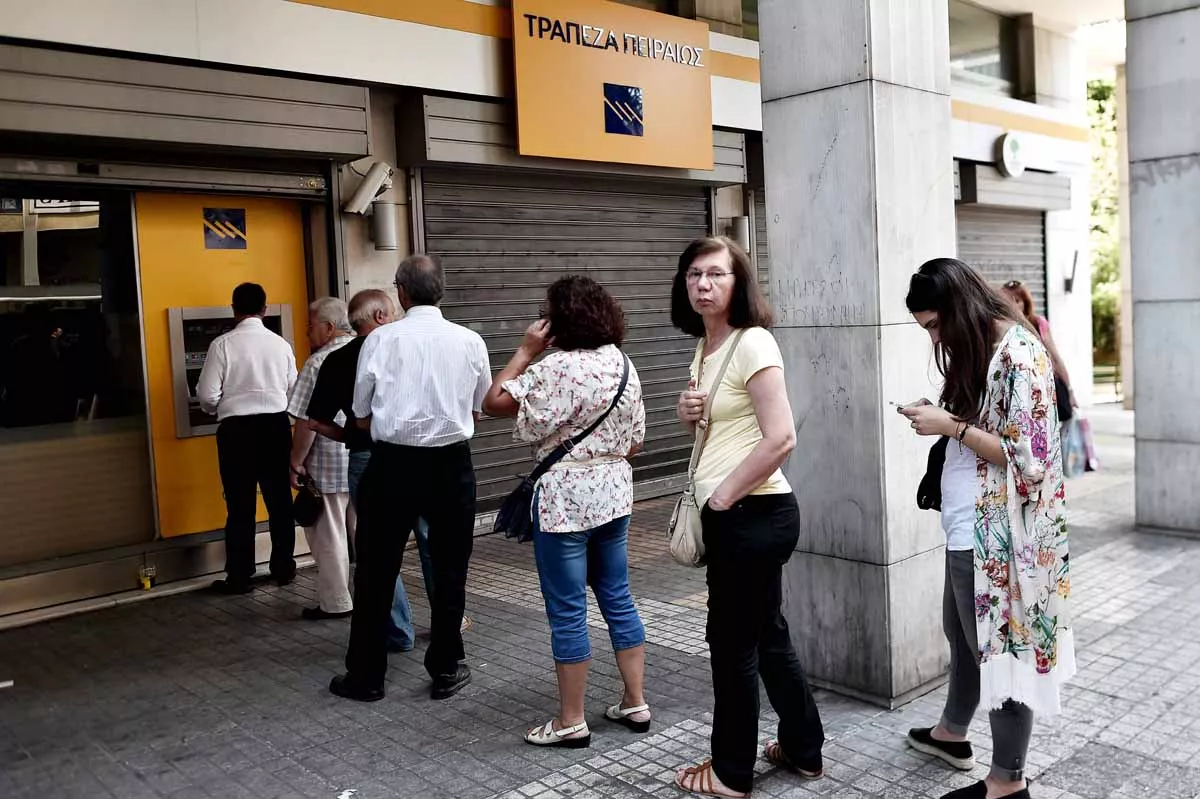 people queue to withdraw cash from an atm machine in central athens on june 30 2015 photo afp people queue to withdraw cash from an atm machine in central athens on june 30 2015 photo afp