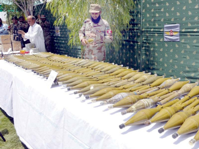 an fc official displays for the media the rockets seized in raids across balochistan photo inp an fc official displays for the media the rockets seized in raids across balochistan photo inp