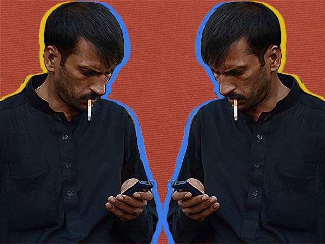 a man checks messages on his mobile phone at a mobile market in rawalpindi photo getty