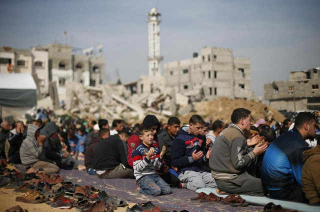 palestinians attend friday prayers near the ruins of houses that witnesses said were destroyed or damaged by israeli shelling during a 50 day war last summer in the shejaia neighbourhood east of gaza city january 23 2015 photo reuters palestinians attend friday prayers near the ruins of houses that witnesses said were destroyed or damaged by israeli shelling during a 50 day war last summer in the shejaia neighbourhood east of gaza city january 23 2015 photo reuters