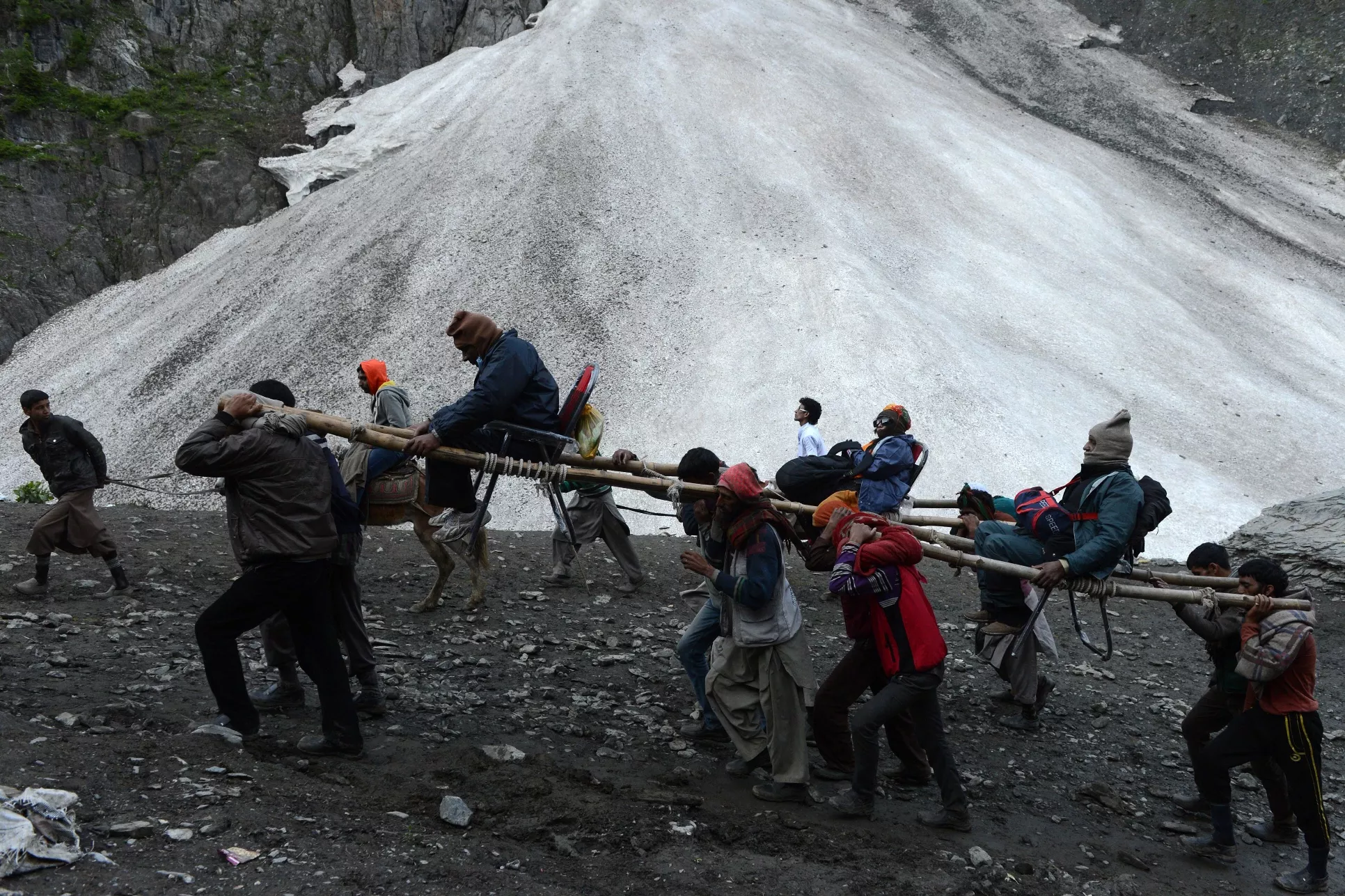 an indian hindu devotee is carried by kashmiri porters during the start of the annual journey from baltal base camp to the holy amarnath cave shrine in baltal near srinagar on july 2 2015 thousands of hindu pilgrims on july 2 2015 began trekking along icy trails to reach a cave shrine high in the mountains of india 039 s restive kashmir amid tight security photo afp an indian hindu devotee is carried by kashmiri porters during the start of the annual journey from baltal base camp to the holy amarnath cave shrine in baltal near srinagar on july 2 2015 thousands of hindu pilgrims on july 2 2015 began trekking along icy trails to reach a cave shrine high in the mountains of india 039 s restive kashmir amid tight security photo afp