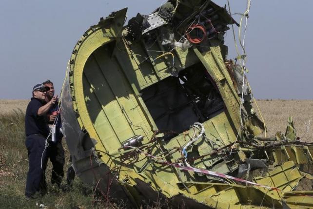 members of a group of international experts inspect wreckage at the site where the downed malaysia airlines flight mh17 crashed near the village of hrabove grabovo in donetsk region eastern ukraine august 1 2014 photo reuters