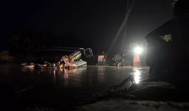 rescue workers and troops inspect the wreckage of a train carrying soldiers and military hardware after it fell into a canal following the partial collapse of a bridge in wazirabad photo afp rescue workers and troops inspect the wreckage of a train carrying soldiers and military hardware after it fell into a canal following the partial collapse of a bridge in wazirabad photo afp