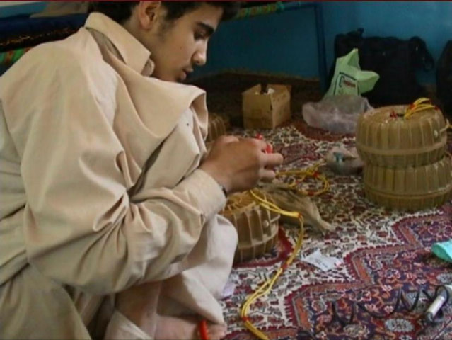 in this image released by the us defense press operations pentagon on october 31 2010 shows canadian omar khadr constructing an improvised explosive device photo afp