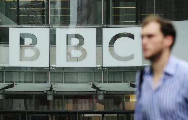 a pedestrian walks past a bbc logo at broadcasting house in central london photo reuters a pedestrian walks past a bbc logo at broadcasting house in central london photo reuters