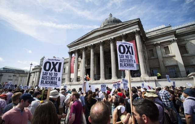 an anti austerity demonstrators attend a rally in trafalgar square in central london on july 4 2015 in solidarity with those voting 039 no 039 in greece 039 s forthcoming referendum greece braced itself saturday ahead of a make or break bailout referendum as polls showed the 039 yes 039 and 039 no 039 camps neck and neck and uncertainty rose over the future of the country 039 s battered economy afp photo an anti austerity demonstrators attend a rally in trafalgar square in central london on july 4 2015 in solidarity with those voting 039 no 039 in greece 039 s forthcoming referendum greece braced itself saturday ahead of a make or break bailout referendum as polls showed the 039 yes 039 and 039 no 039 camps neck and neck and uncertainty rose over the future of the country 039 s battered economy afp photo