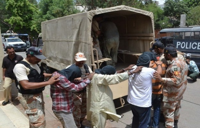 rangers load suspects arrested after a raid into trucks in karachi photo ppi rangers load suspects arrested after a raid into trucks in karachi photo ppi
