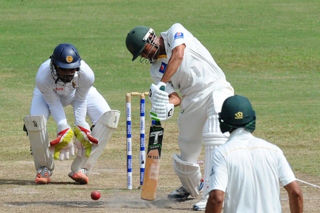 pakistan cricketer younis khan c plays a shot as sri lankan wicketkeeper dinesh chandimal l looks on during the fourth day of the third and final test cricket match between sri lanka and pakistan at the pallekele international cricket stadium in pallekele on july 6 2015 photo afp