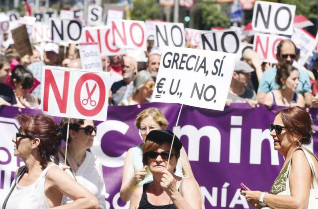 a woman holds a placard reading greece yes eu no during a demonstration in support of greece in madrid on sunday photo afp a woman holds a placard reading greece yes eu no during a demonstration in support of greece in madrid on sunday photo afp