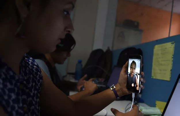 an employee of indian technology company 039 frankly me 039 uses a phone to test their app at an office in noida on the outskirts of new delhi photo afp an employee of indian technology company 039 frankly me 039 uses a phone to test their app at an office in noida on the outskirts of new delhi photo afp