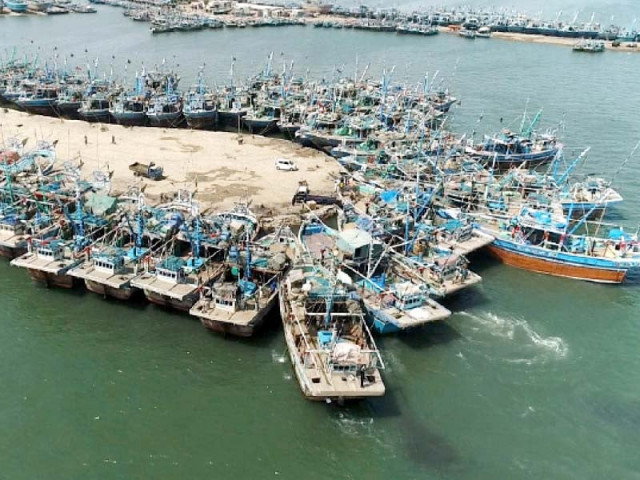fishing boats are anchored at the ibrahim hyderi jetty due to the cyclone warning in the coastal areas of sindh and balochi stan photo express fishing boats are anchored at the ibrahim hyderi jetty due to the cyclone warning in the coastal areas of sindh and balochi stan photo express