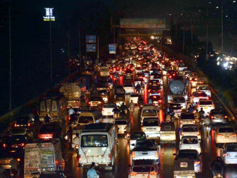 cars stuck in traffic jam at sharae faisal due to mild rain in karachi photo ppi