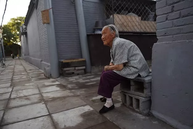 this photo taken on july 1 2015 shows 95 year old yan guiru sitting outside her home in a residential neighborhood near the marco polo bridge or lugouqiao in west beijing photo afp this photo taken on july 1 2015 shows 95 year old yan guiru sitting outside her home in a residential neighborhood near the marco polo bridge or lugouqiao in west beijing photo afp