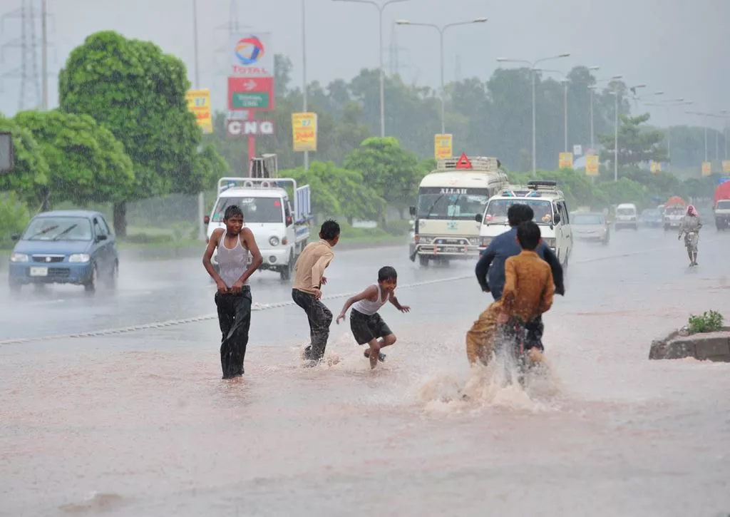 children play in monsoon rain in pakistan photo afp children play in monsoon rain in pakistan photo afp