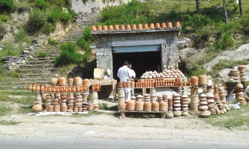 some of the earthenware is scattered outside the shop and also placed on its roof the only form of advertisement rahmat can afford photos muhammad irfan express