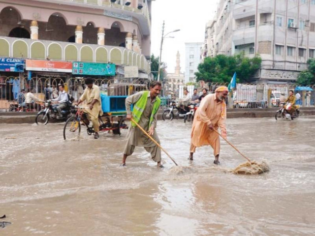 civic staff struggle to clear the roads of water in karachi heavy rains create havoc in the city as there is a lack of management photo file civic staff struggle to clear the roads of water in karachi heavy rains create havoc in the city as there is a lack of management photo file