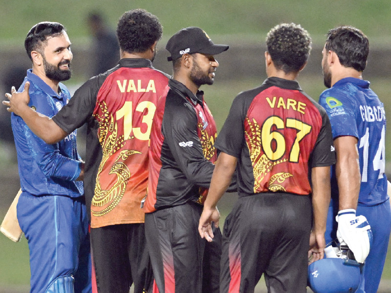 afghanistan s gulbadin naib l and mohammad nabi l are being after congratulated by papua new guinea s players after they won the twenty20 world cup 2024 group c match on friday photo afp