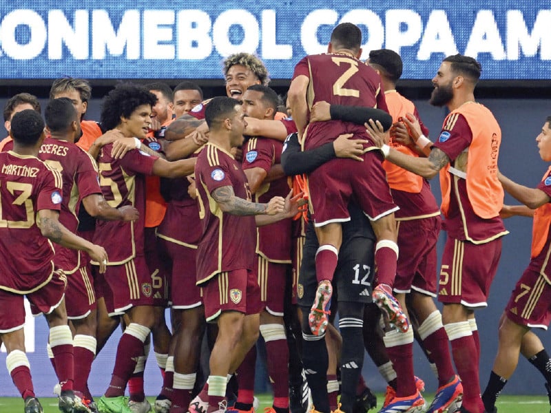 venezuela s players mob goalscorer salomon rondon after his decisive penalty in the 1 0 win over mexico photo afp