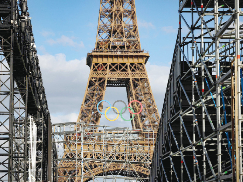 olympic rings on the eiffel tower are seen through the construction site of parc des champions at the trocadero for the upcoming 2024 games in paris photo reuters