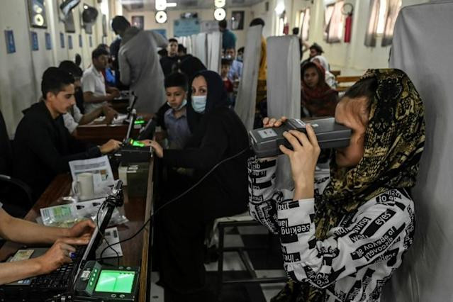 applicants need to have their picture taken eyes biometrically recorded and fingerprints taken as part of the process with a thorough security frisk thrown in for good measure afp