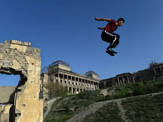in this photo taken on april 24 2015 an afghan youth practices his parkour skills in front of the ruins of darul aman palace in kabul photo afp in this photo taken on april 24 2015 an afghan youth practices his parkour skills in front of the ruins of darul aman palace in kabul photo afp