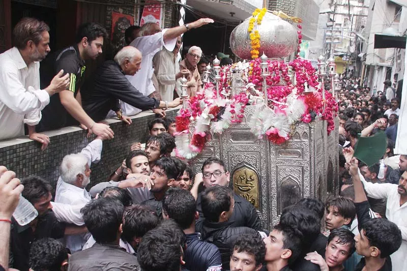 participants of the main mourning procession carrying the traditional zareeh a metallic model of hazrat ali s shrine as it passed from mochi gate on thursday photo abid nawaz express participants of the main mourning procession carrying the traditional zareeh a metallic model of hazrat ali s shrine as it passed from mochi gate on thursday photo abid nawaz express