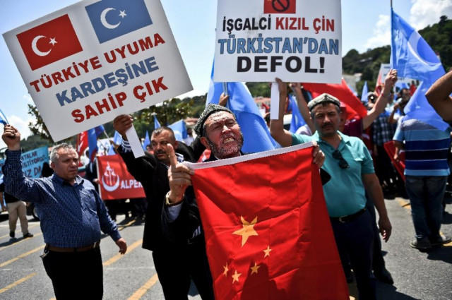 turkish nationalists holding placards and the chinese flag protest outside the chinese consulate in istanbul on july 5 2015 to denounce china 039 s treatment of ethnic uighur muslims photo afp turkish nationalists holding placards and the chinese flag protest outside the chinese consulate in istanbul on july 5 2015 to denounce china 039 s treatment of ethnic uighur muslims photo afp