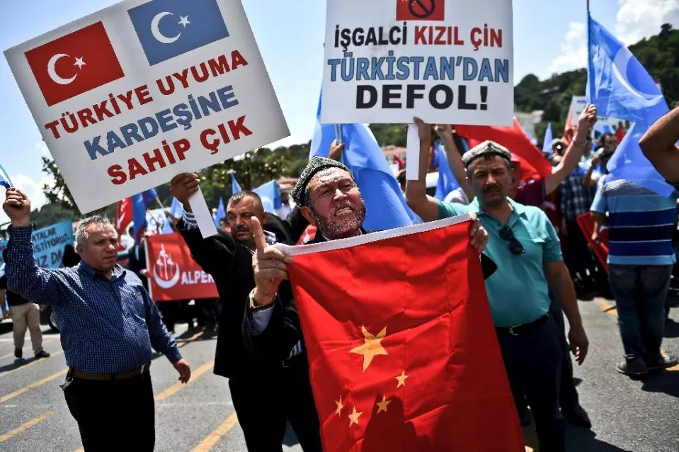 turkish nationalists holding placards and the chinese flag protest outside the chinese consulate in istanbul on july 5 2015 to denounce china 039 s treatment of ethnic uighur muslims photo afp turkish nationalists holding placards and the chinese flag protest outside the chinese consulate in istanbul on july 5 2015 to denounce china 039 s treatment of ethnic uighur muslims photo afp