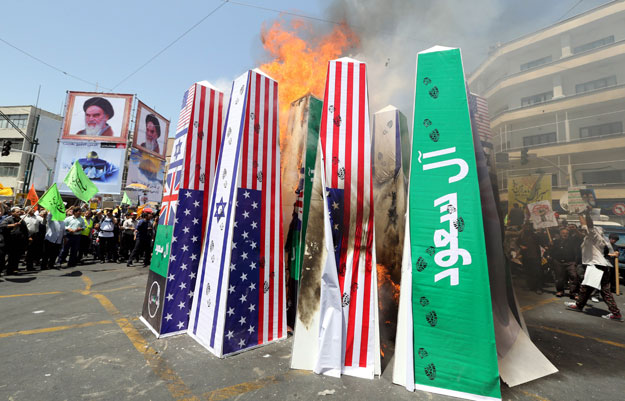 iranian protesters burn israeli american and saudi arabian flags during a demonstration to mark the quds jerusalem international day in tehran photo afp