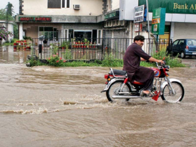 a road flooded with rainwater in abbottabad photo online a road flooded with rainwater in abbottabad photo online