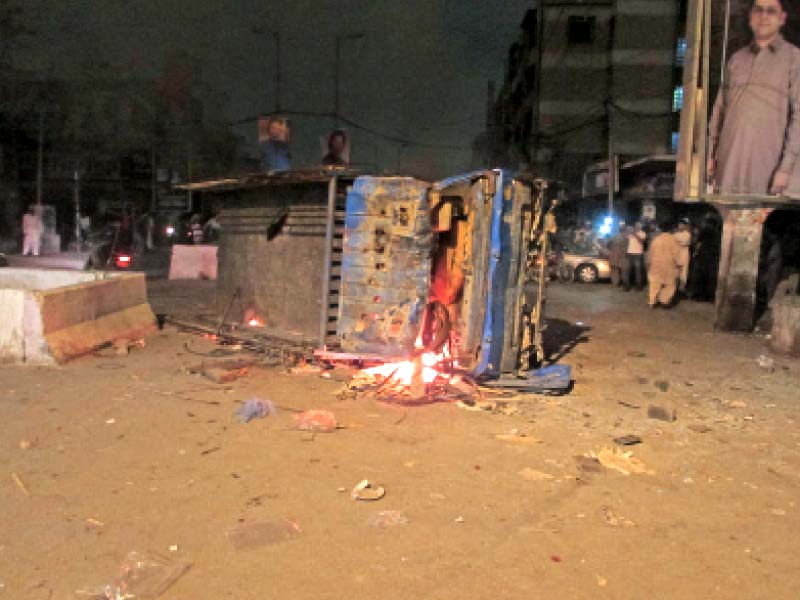 an angry mob sets fire to a vehicle in hyderi market on friday a clash had erupted between shopkeepers and the deputy commissioner as the latter tried to rid the area of encroachments photo mohammad noman express