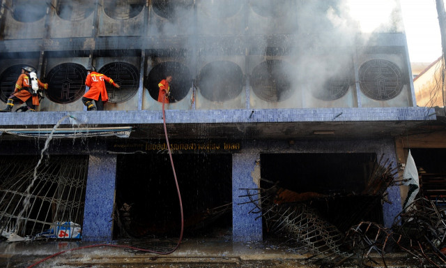 thai firefighters spray water on burning buildings from a bomb attack by suspected separatist militants in sungai kolok in thailand s southern province of narathiwat photo afp thai firefighters spray water on burning buildings from a bomb attack by suspected separatist militants in sungai kolok in thailand s southern province of narathiwat photo afp