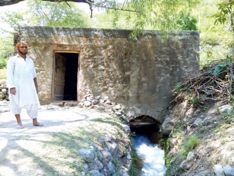 a man stands outside the mill in shahdara top a view of the grinder inside the mill bottom photos shazia mehboob express