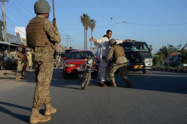 an afghan soldier searches commuters as others look on at a checkpoint in jalalabad in nangarhar province on april 22 2015 photo afp an afghan soldier searches commuters as others look on at a checkpoint in jalalabad in nangarhar province on april 22 2015 photo afp