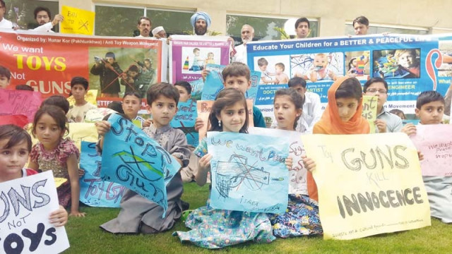 children carry placards with slogans against toy guns inscribed on them photo express children carry placards with slogans against toy guns inscribed on them photo express