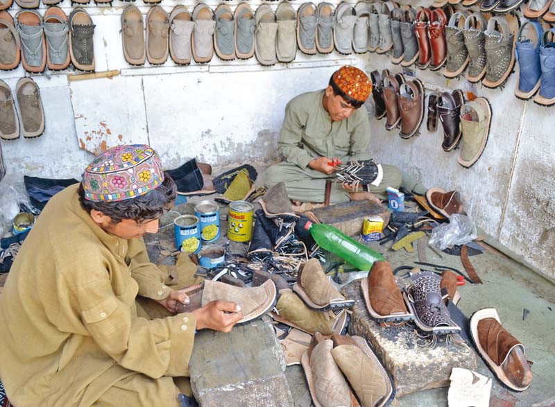 shoemakers put the finishing touches to their work in a quetta shop photo naseem james express