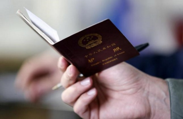 a police officer checks the passport of a chinese immigrant at the shen wu textile factory in prato december 9 2013 photo reuters a police officer checks the passport of a chinese immigrant at the shen wu textile factory in prato december 9 2013 photo reuters