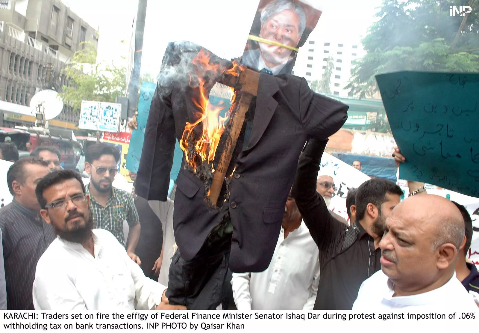 traders in karachi burning an effigy of finance minister ishaq dar to protest against the imposition of 0 6 withholding tax on all bank transactions photo inp traders in karachi burning an effigy of finance minister ishaq dar to protest against the imposition of 0 6 withholding tax on all bank transactions photo inp
