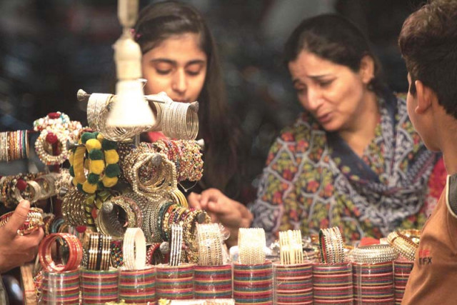 women inspect bangles at a stall set up in front of a shop in anarkali market photo shafiq malik express women inspect bangles at a stall set up in front of a shop in anarkali market photo shafiq malik express