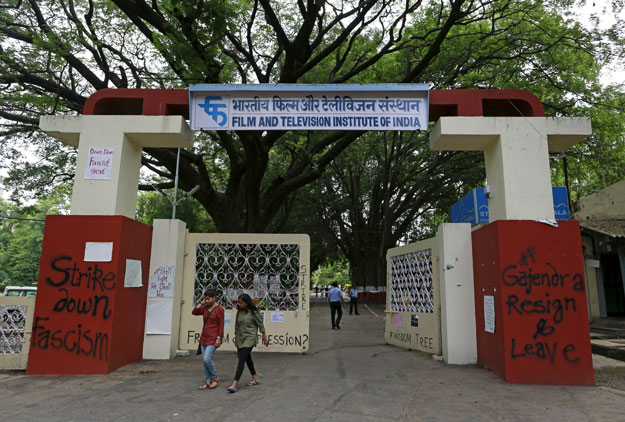 students walk past the graffiti painted entrance of the film and television institute of india ftii in pune india photo reuters