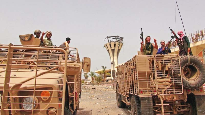 southern resistance fighters ride armoured personnel carriers at the international airport of yemen s southern port city of aden photo reuters