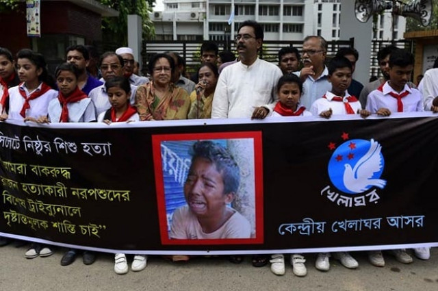 bangladeshi protesters carry a banner during a demonstration against the lynching of a 13 year old boy in dhaka photo afp
