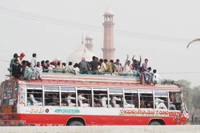 a bus full to overflowing travelling near minar i pakistan on thursday photo shafiq malik express a bus full to overflowing travelling near minar i pakistan on thursday photo shafiq malik express