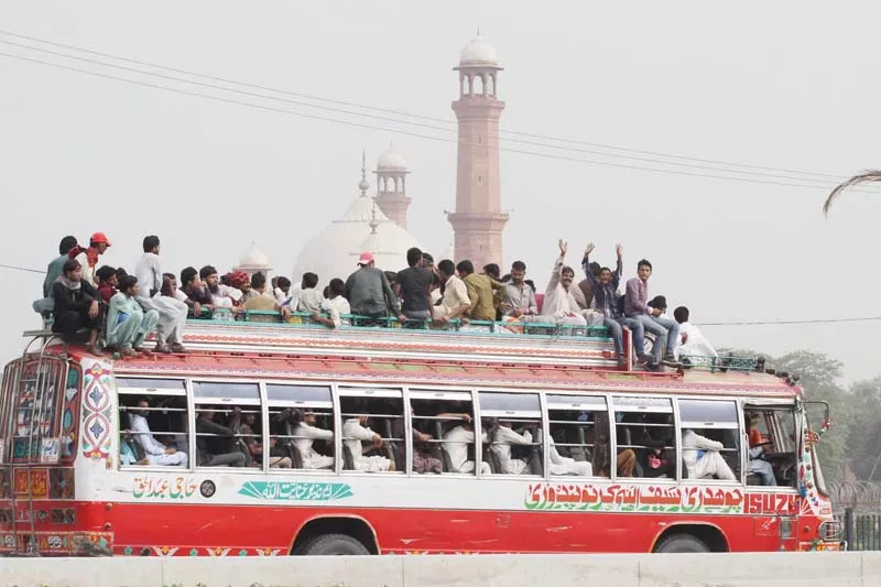 a bus full to overflowing travelling near minar i pakistan on thursday photo shafiq malik express a bus full to overflowing travelling near minar i pakistan on thursday photo shafiq malik express