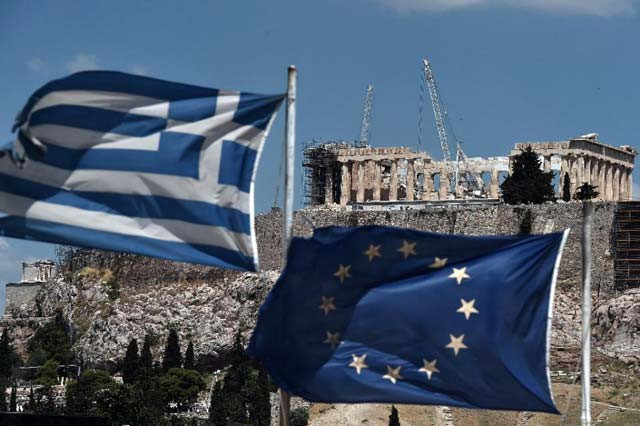 an eu and a greek flag in front of the ancient temple of parthenon atop the acropolis hill in athens photo afp an eu and a greek flag in front of the ancient temple of parthenon atop the acropolis hill in athens photo afp